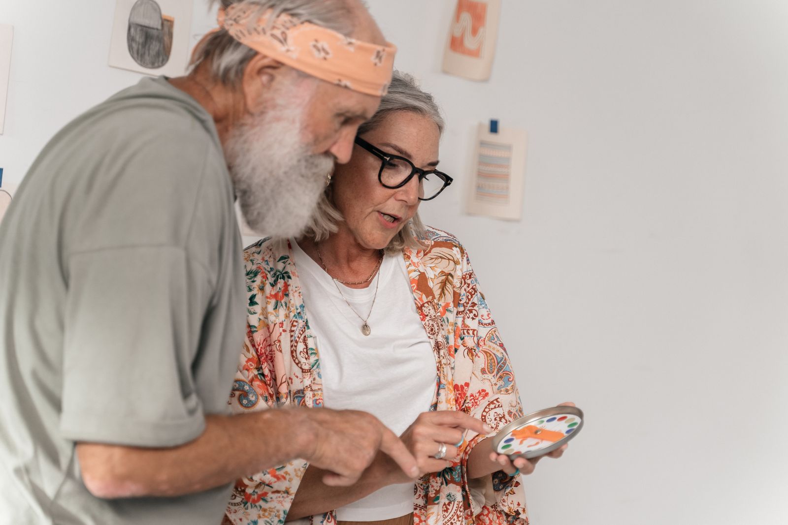 An elderly woman and a man sharing a handmade creation together