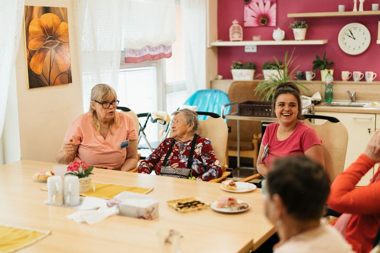 Seniors gathered around a table in a senior living community